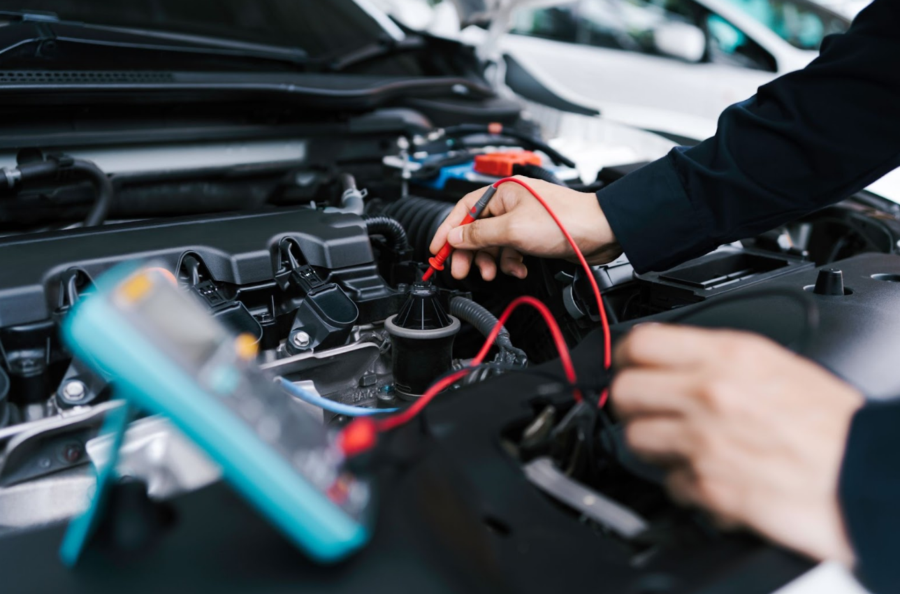 Mechanic inspects engine bay with light—troubleshooting issue after the vehicle’s engine locked up.