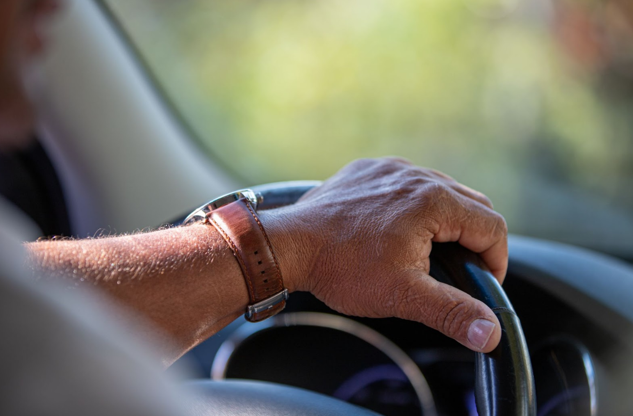 Close-up of a driver’s hand on a steering wheel, while they deal with their GMC Super Cruise not working
