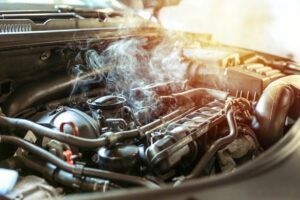 Smoke rises from an overheated Jeep engine bay, highlighting the Jeep recall fire risk under the hood.